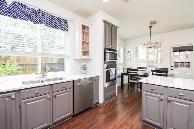 9611 Haven Crossing Ct, Houston, TX 77065 - kitchen with appliances with stainless steel finishes, gray cabinets, a sink, and dark wood finished floors