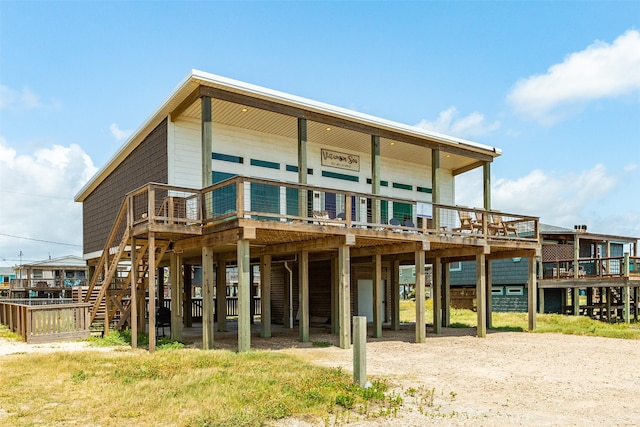706 Beach Dr, Surfside Beach, TX 77541 - rear view of property featuring a carport, a wooden deck, driveway, and stairway