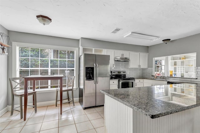 2138 Middle Creek Dr, Houston, TX 77339 - kitchen with stainless steel appliances, under cabinet range hood, a sink, dark stone counters, and white cabinets