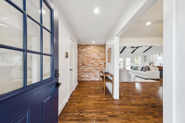 7811 Skyline Dr, Houston, TX 77063 - foyer with brick wall, dark wood-type flooring, recessed lighting, ceiling fan, and beamed ceiling