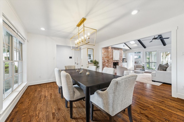 7811 Skyline Dr, Houston, TX 77063 - dining space with dark wood finished floors, baseboards, a fireplace, crown molding, and a ceiling fan
