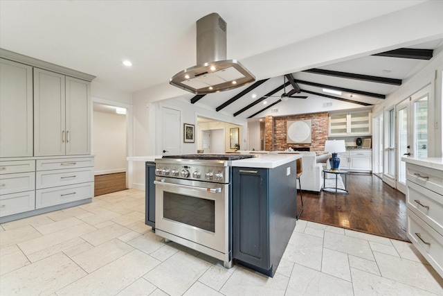 7811 Skyline Dr, Houston, TX 77063 - kitchen with high end range, island exhaust hood, open floor plan, gray cabinets, and light countertops