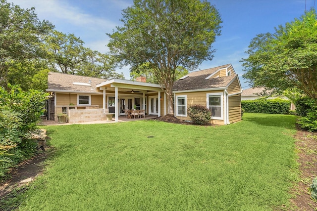 7811 Skyline Dr, Houston, TX 77063 - back of property featuring a ceiling fan, a yard, a patio area, a shingled roof, and a chimney