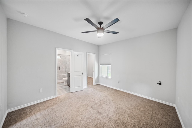 4006 Frontier Rd, Willis, TX 77378 - unfurnished bedroom with carpet floors, baseboards, ensuite bathroom, and ceiling fan