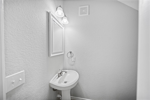 4006 Frontier Rd, Willis, TX 77378 - bathroom with a textured wall and a sink
