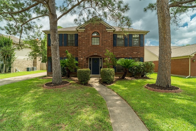 14515 Redbud Valley Trl, Houston, TX 77062 - view of front of house featuring brick siding, a front lawn, and cooling unit