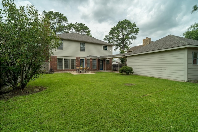 14515 Redbud Valley Trl, Houston, TX 77062 - back of house featuring a patio, brick siding, a shingled roof, and a chimney