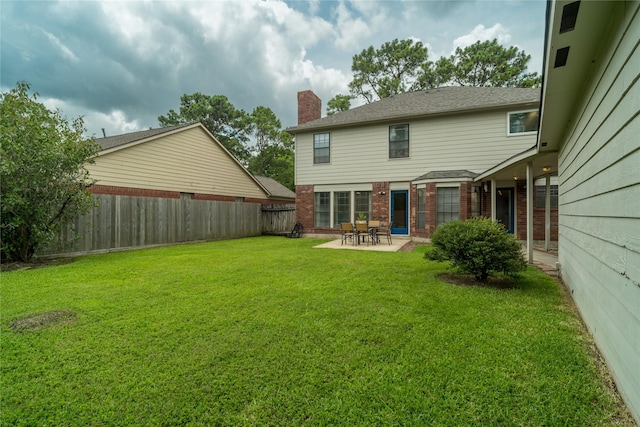 14515 Redbud Valley Trl, Houston, TX 77062 - rear view of house with a patio area, brick siding, and a chimney