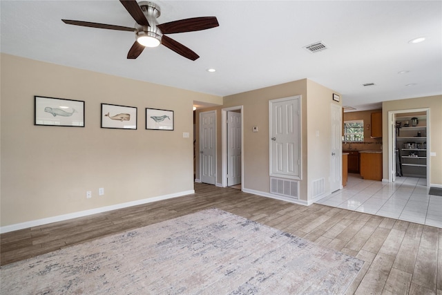 14515 Redbud Valley Trl, Houston, TX 77062 - unfurnished living room featuring light wood finished floors, a ceiling fan, baseboards, and recessed lighting