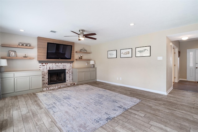 14515 Redbud Valley Trl, Houston, TX 77062 - unfurnished living room featuring wood finished floors, a ceiling fan, baseboards, a brick fireplace, and recessed lighting