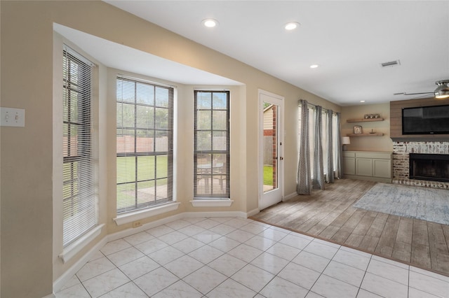 14515 Redbud Valley Trl, Houston, TX 77062 - entrance foyer featuring a brick fireplace, baseboards, a ceiling fan, tile patterned flooring, and recessed lighting