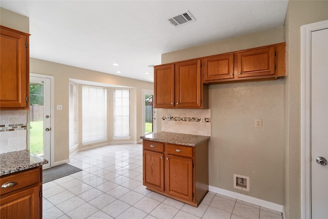 14515 Redbud Valley Trl, Houston, TX 77062 - kitchen featuring brown cabinetry, backsplash, and recessed lighting