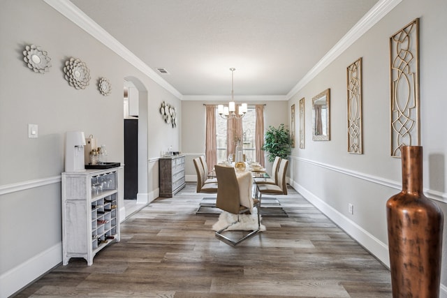 28243 Shorecrest Ln, Katy, TX 77494 - dining area featuring a chandelier, ornamental molding, arched walkways, wood finished floors, and baseboards