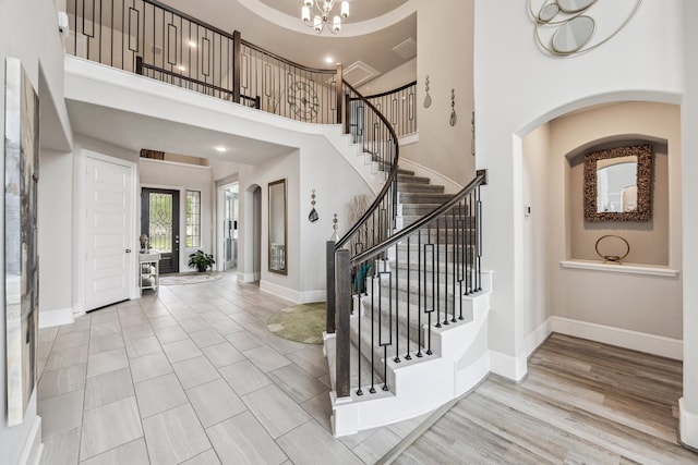 28243 Shorecrest Ln, Katy, TX 77494 - entrance foyer featuring stairway, arched walkways, a towering ceiling, baseboards, and a chandelier