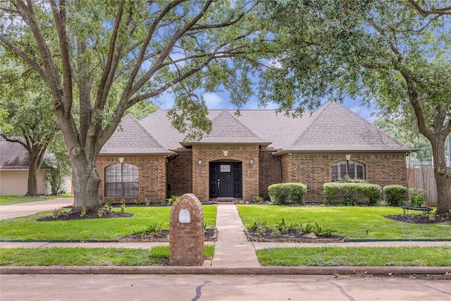 2205 Erin Glen Ct, Deer Park, TX 77536 - french country style house featuring brick siding and roof with shingles