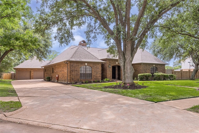2205 Erin Glen Ct, Deer Park, TX 77536 - french country inspired facade featuring brick siding, concrete driveway, a chimney, and roof with shingles