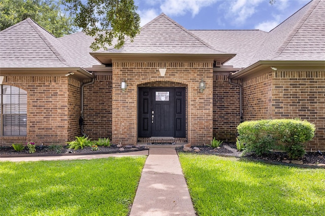 2205 Erin Glen Ct, Deer Park, TX 77536 - doorway to property with brick siding, a yard, and roof with shingles