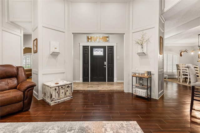 2205 Erin Glen Ct, Deer Park, TX 77536 - entryway featuring a decorative wall, dark wood finished floors, a chandelier, and ornamental molding