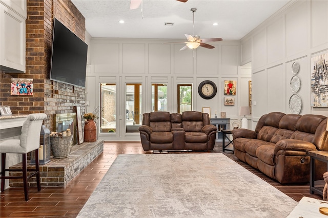 2205 Erin Glen Ct, Deer Park, TX 77536 - living area with a decorative wall, a ceiling fan, wood finished floors, and a high ceiling
