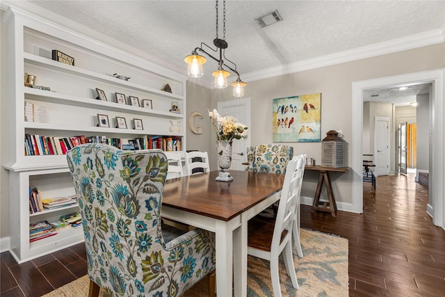 2205 Erin Glen Ct, Deer Park, TX 77536 - dining area featuring a textured ceiling, dark wood-style flooring, crown molding, baseboards, and built in shelves