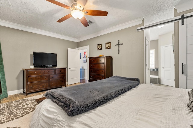 2205 Erin Glen Ct, Deer Park, TX 77536 - bedroom with a barn door, wood finished floors, a textured ceiling, crown molding, and ceiling fan