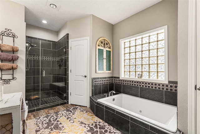 2205 Erin Glen Ct, Deer Park, TX 77536 - full bathroom with a whirlpool tub, a shower stall, wood finished floors, a textured ceiling, and recessed lighting
