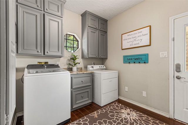 2205 Erin Glen Ct, Deer Park, TX 77536 - washroom featuring cabinet space, dark wood-type flooring, baseboards, a textured ceiling, and washer and dryer