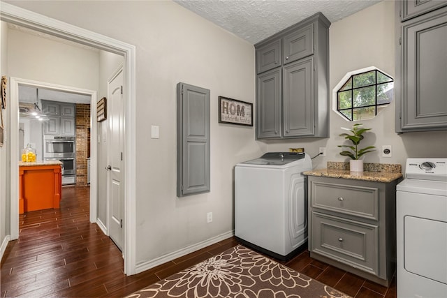 2205 Erin Glen Ct, Deer Park, TX 77536 - washroom featuring washer / dryer, cabinet space, dark wood-type flooring, a textured ceiling, and baseboards