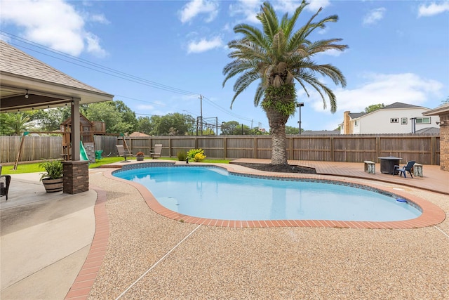 2205 Erin Glen Ct, Deer Park, TX 77536 - view of swimming pool featuring a playground, a fenced backyard, a patio, and a wooden deck