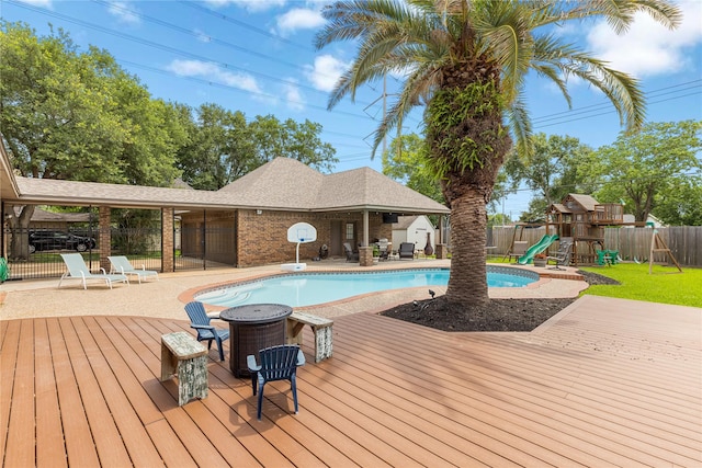 2205 Erin Glen Ct, Deer Park, TX 77536 - view of pool with a playground and a wooden deck