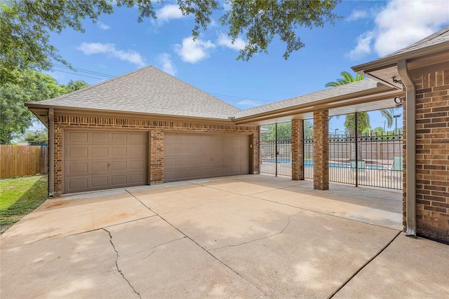 2205 Erin Glen Ct, Deer Park, TX 77536 - view of front facade with roof with shingles, brick siding, an attached garage, and concrete driveway