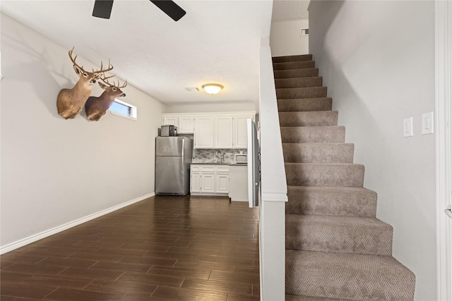 2205 Erin Glen Ct, Deer Park, TX 77536 - stairs featuring ceiling fan, wood finished floors, and baseboards