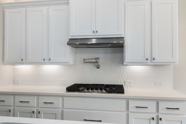 5115 Prairie Gourd Mdw, Manvel, TX 77578 - kitchen featuring under cabinet range hood, stainless steel gas cooktop, light countertops, and backsplash