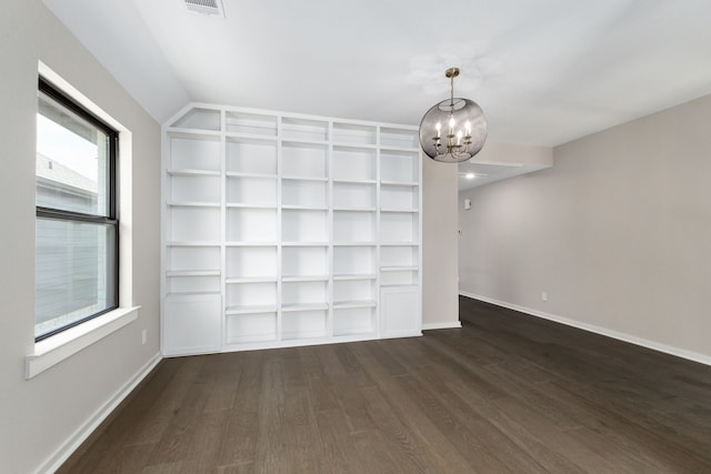 5115 Prairie Gourd Mdw, Manvel, TX 77578 - empty room featuring dark wood-style floors, a chandelier, baseboards, and built in features