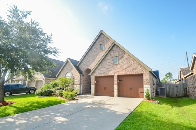 13806 Crystal Harbor Ln, Pearland, TX 77584 - view of front of property with central AC, brick siding, concrete driveway, an attached garage, and stone siding
