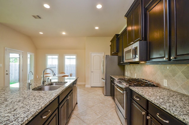 13806 Crystal Harbor Ln, Pearland, TX 77584 - kitchen with stainless steel appliances, a sink, backsplash, light stone counters, and recessed lighting