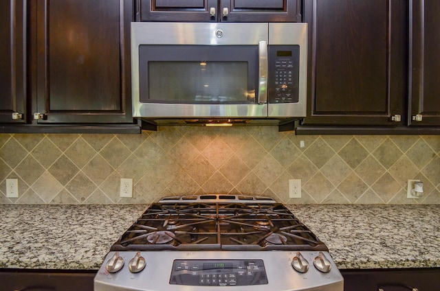 13806 Crystal Harbor Ln, Pearland, TX 77584 - kitchen with stainless steel appliances, dark brown cabinetry, and backsplash