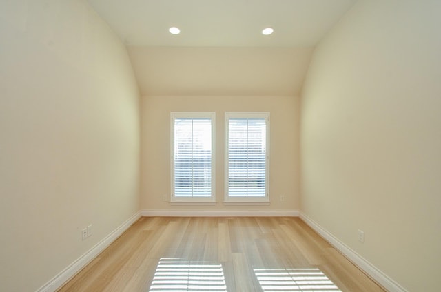 13806 Crystal Harbor Ln, Pearland, TX 77584 - spare room featuring light wood-style flooring, baseboards, vaulted ceiling, and recessed lighting
