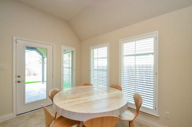 13806 Crystal Harbor Ln, Pearland, TX 77584 - dining area with baseboards, lofted ceiling, and light tile patterned floors