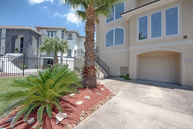2242 Marina Way, League City, TX 77565 - view of front of home with stucco siding, an attached garage, and driveway