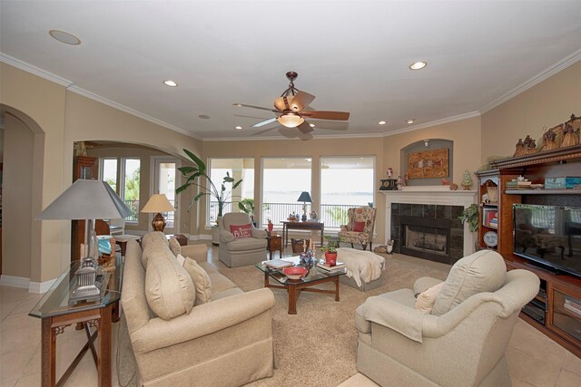 2242 Marina Way, League City, TX 77565 - living area featuring ceiling fan, arched walkways, a tiled fireplace, recessed lighting, and ornamental molding