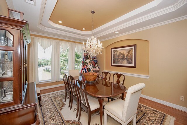 2242 Marina Way, League City, TX 77565 - dining room featuring a raised ceiling, a chandelier, wood finished floors, ornamental molding, and recessed lighting
