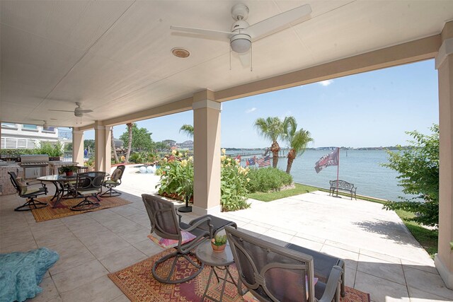 2242 Marina Way, League City, TX 77565 - view of patio featuring ceiling fan, outdoor dining area, a water view, and exterior kitchen