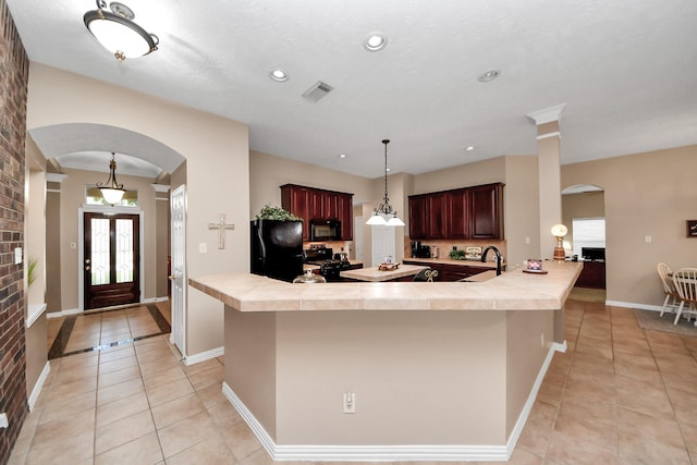 18110 Dovefield Ln, Cypress, TX 77433 - kitchen featuring black appliances, arched walkways, light tile patterned floors, and recessed lighting