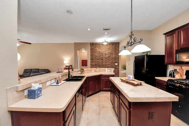 18110 Dovefield Ln, Cypress, TX 77433 - kitchen featuring black appliances, light countertops, a center island, light tile patterned floors, and open floor plan