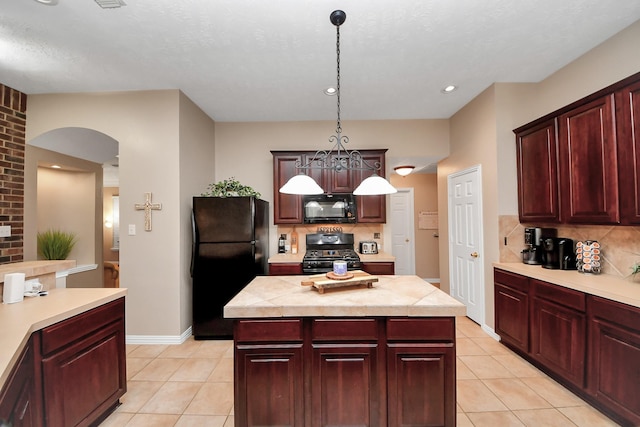 18110 Dovefield Ln, Cypress, TX 77433 - kitchen with black appliances, light countertops, decorative backsplash, light tile patterned floors, and recessed lighting