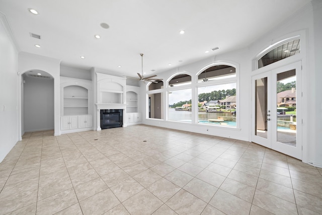 169 Westlake Pt, Montgomery, TX 77356 - unfurnished living room with crown molding, light tile patterned floors, recessed lighting, built in features, and a water view
