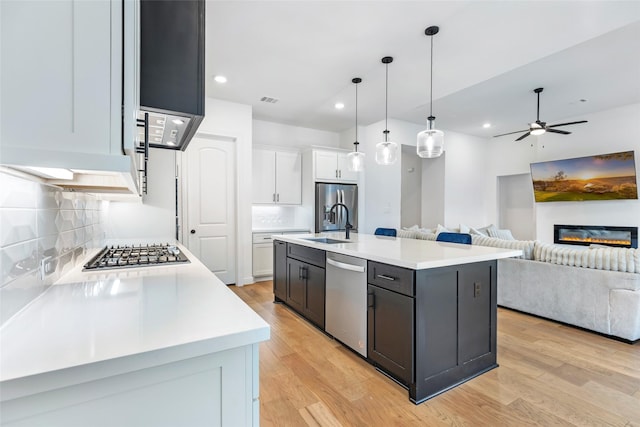 11914 Parsifal Creek Rd, Humble, TX 77346 - kitchen featuring appliances with stainless steel finishes, white cabinetry, light countertops, backsplash, and recessed lighting