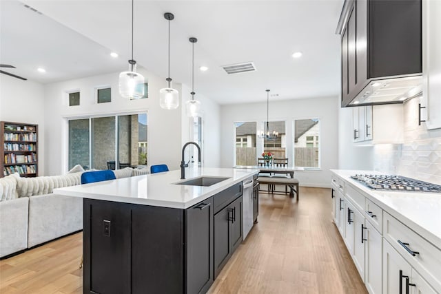 11914 Parsifal Creek Rd, Humble, TX 77346 - kitchen with a sink, open floor plan, appliances with stainless steel finishes, light wood finished floors, and recessed lighting