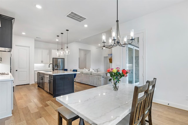 11914 Parsifal Creek Rd, Humble, TX 77346 - dining area featuring a chandelier, light wood finished floors, recessed lighting, and baseboards